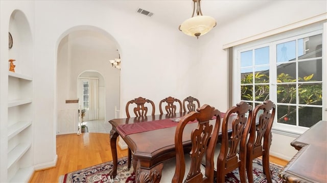1511 Coolidge Ave, Pasadena, CA 91104 - dining room with built in features, light wood-style floors, and arched walkways