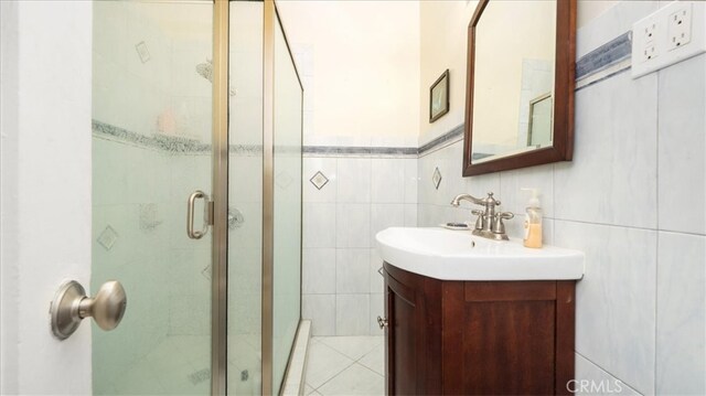1511 Coolidge Ave, Pasadena, CA 91104 - bathroom with a stall shower, vanity, and tile walls