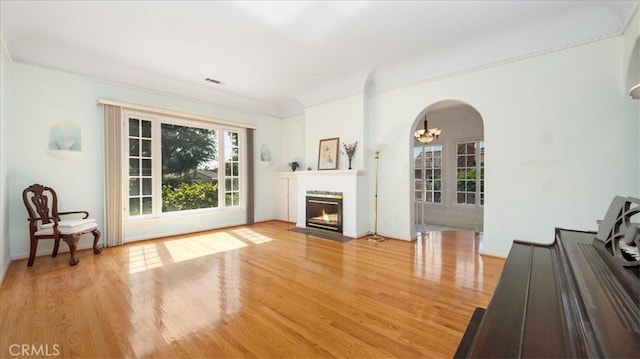 1511 Coolidge Ave, Pasadena, CA 91104 - living area with wood finished floors, arched walkways, and a fireplace with flush hearth
