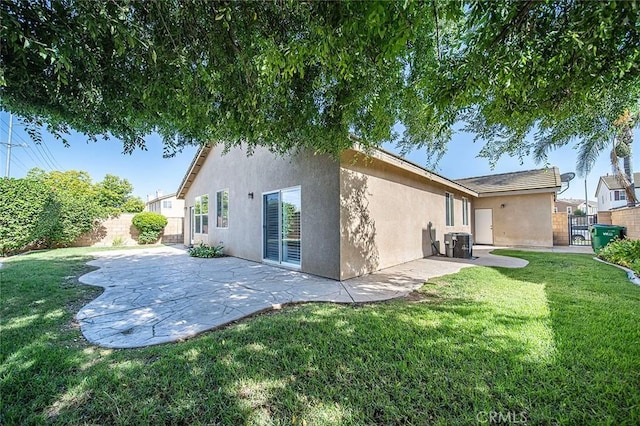 12750 Jack Ln, Eastvale, CA 92880 - rear view of house featuring stucco siding, a gate, a patio, and cooling unit
