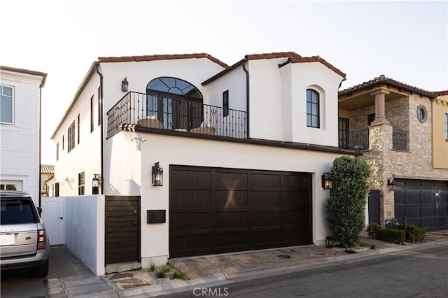 110 Via Orvieto, Newport Beach, CA 92663 - view of front of house featuring a balcony, stucco siding, a garage, and a gate