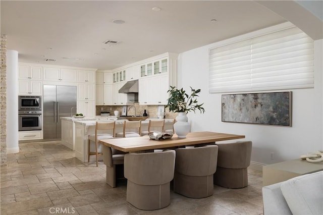 110 Via Orvieto, Newport Beach, CA 92663 - dining space featuring arched walkways and light stone finish floors