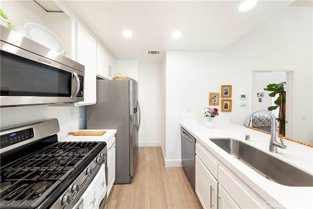 28107 Caldaro, Laguna Niguel, CA 92677 - kitchen featuring stainless steel appliances, a sink, light wood-type flooring, white cabinets, and recessed lighting