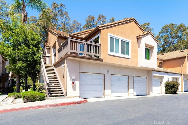 28107 Caldaro, Laguna Niguel, CA 92677 - view of front of property with stairs, stucco siding, an attached garage, and a balcony