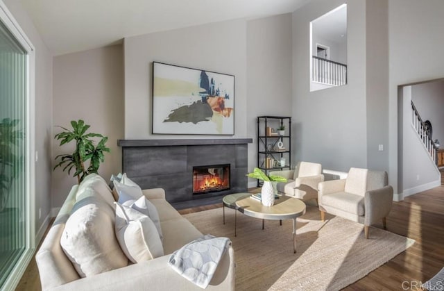 1808 Amalfi Dr, Encinitas, CA 92024 - living area featuring a fireplace, wood finished floors, and stairs