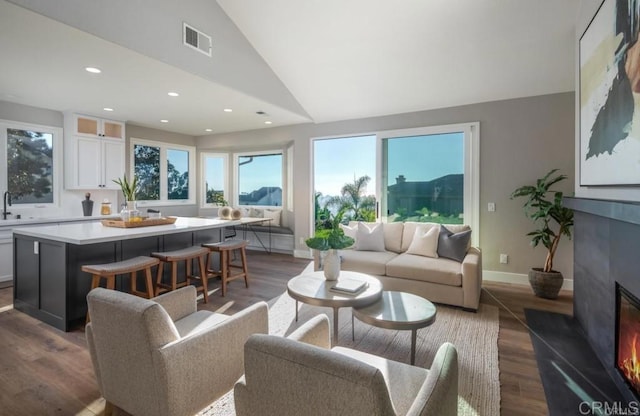 1808 Amalfi Dr, Encinitas, CA 92024 - living area with lofted ceiling, a glass covered fireplace, dark wood-style flooring, and recessed lighting