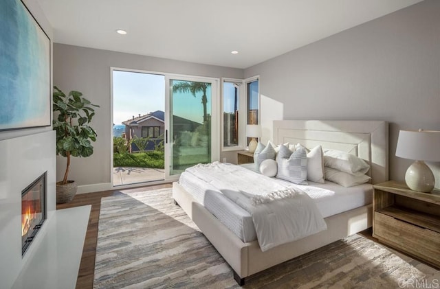 1808 Amalfi Dr, Encinitas, CA 92024 - bedroom featuring access to exterior, wood finished floors, a glass covered fireplace, and recessed lighting