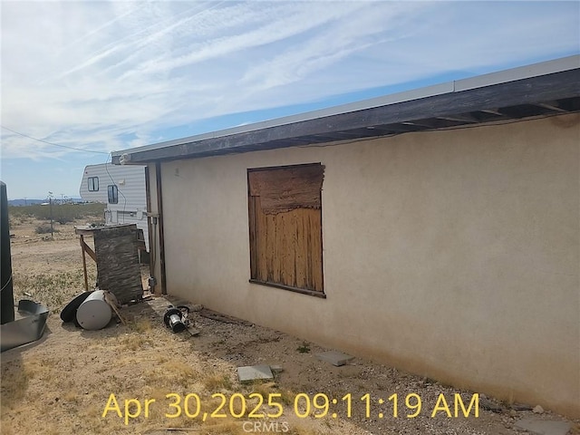 view of side of home featuring stucco siding