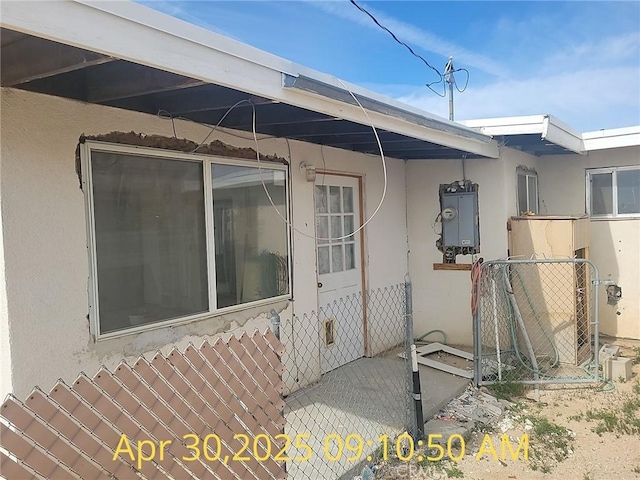 view of home's exterior featuring stucco siding and a gate
