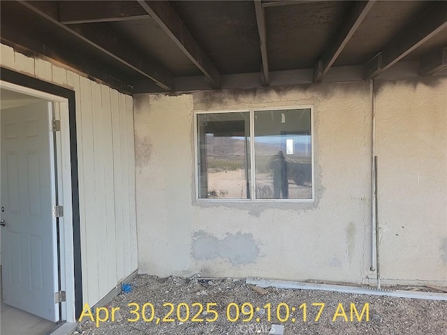 entrance to property with stucco siding