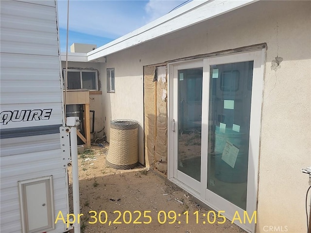 exterior view of stucco siding and cooling unit