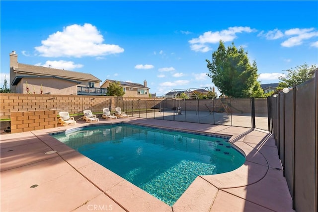 view of swimming pool with a patio area and a fenced backyard