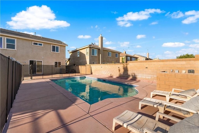 view of pool featuring a patio, a fenced backyard, and a residential view