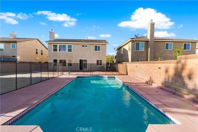 view of swimming pool with a fenced backyard and a patio