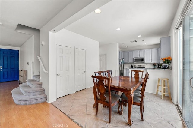 dining room with recessed lighting, stairway, and light tile patterned flooring