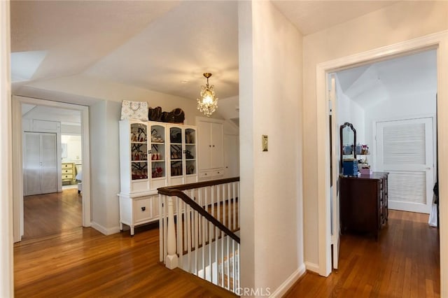 4225 Myrtle Ave, Long Beach, CA 90807 - corridor featuring an upstairs landing, dark wood-style flooring, a chandelier, and baseboards