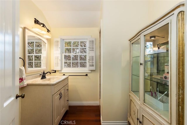 4225 Myrtle Ave, Long Beach, CA 90807 - bathroom featuring wood finished floors, baseboards, vaulted ceiling, and vanity