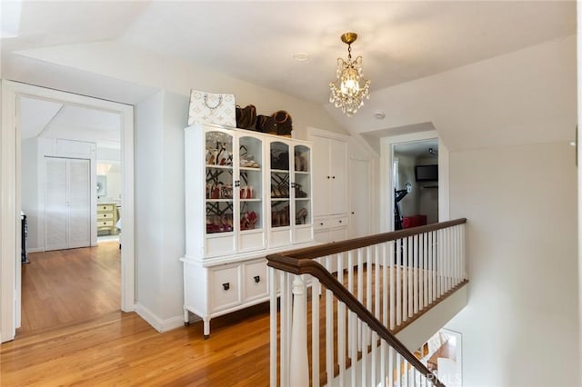 4225 Myrtle Ave, Long Beach, CA 90807 - hall featuring an upstairs landing, light wood-style floors, lofted ceiling, a chandelier, and baseboards