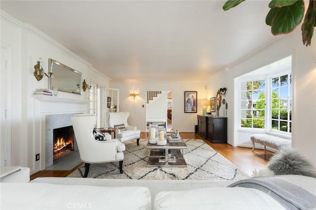 4225 Myrtle Ave, Long Beach, CA 90807 - living room with wood finished floors, a fireplace with flush hearth, crown molding, and stairs