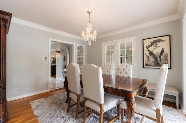4225 Myrtle Ave, Long Beach, CA 90807 - dining room featuring wood finished floors, a chandelier, ornamental molding, and baseboards