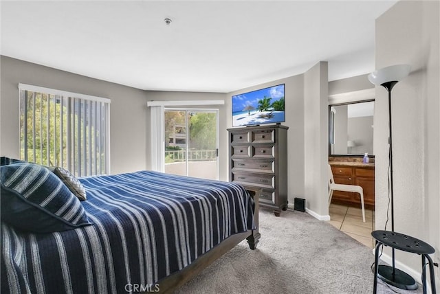 1980 Las Colinas Cir Unit 301, Corona, CA 92879 - bedroom featuring light carpet, light tile patterned floors, and ensuite bath
