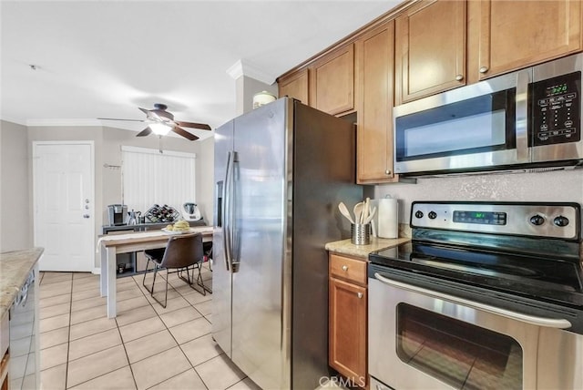 1980 Las Colinas Cir Unit 301, Corona, CA 92879 - kitchen featuring appliances with stainless steel finishes, crown molding, ceiling fan, light tile patterned floors, and brown cabinetry