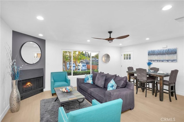 34582 Calle Rosita, Dana Point, CA 92624 - living room with recessed lighting, light wood-type flooring, healthy amount of natural light, a warm lit fireplace, and a ceiling fan