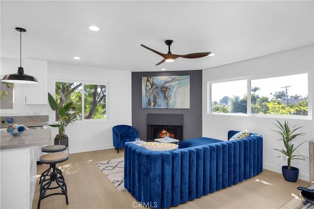 34582 Calle Rosita, Dana Point, CA 92624 - living area with a warm lit fireplace, baseboards, recessed lighting, a ceiling fan, and light wood-type flooring