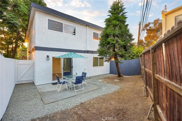 34582 Calle Rosita, Dana Point, CA 92624 - rear view of house with stucco siding, a gate, a patio area, and a fenced backyard