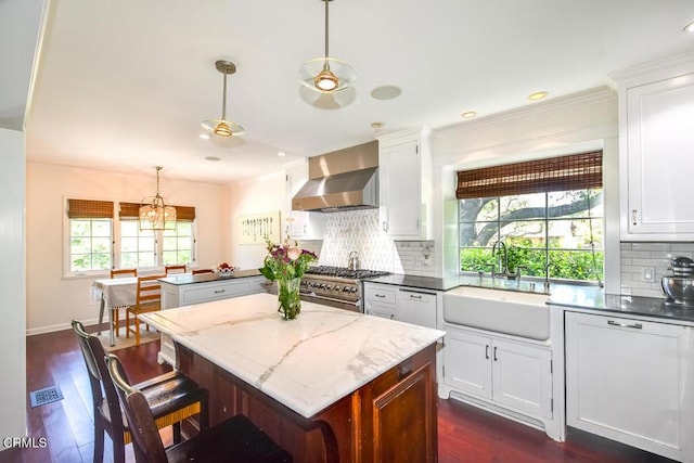 1908 Warwick Rd, San Marino, CA 91108 - kitchen featuring wall chimney exhaust hood, a sink, high end stainless steel range oven, a kitchen island, and healthy amount of natural light