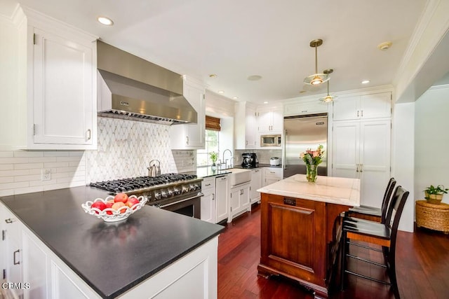 1908 Warwick Rd, San Marino, CA 91108 - kitchen with built in appliances, wall chimney exhaust hood, a sink, dark wood-style floors, and crown molding