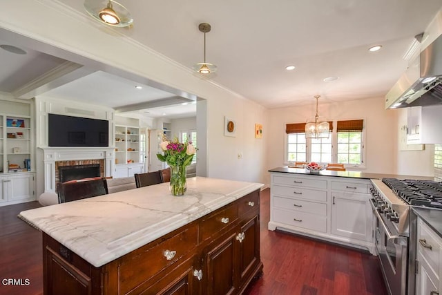 1908 Warwick Rd, San Marino, CA 91108 - kitchen featuring double oven range, wall chimney exhaust hood, dark wood-style flooring, white cabinetry, and a fireplace