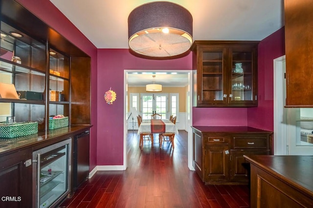 1908 Warwick Rd, San Marino, CA 91108 - kitchen featuring beverage cooler, dark countertops, dark wood-style flooring, baseboards, and glass insert cabinets