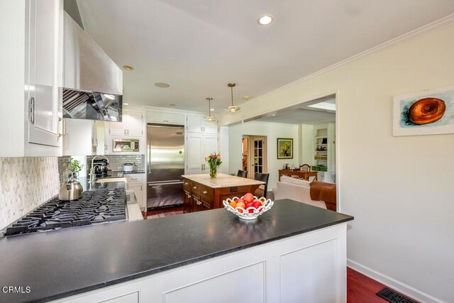 1908 Warwick Rd, San Marino, CA 91108 - kitchen with stainless steel built in refrigerator, exhaust hood, backsplash, white cabinetry, and stovetop