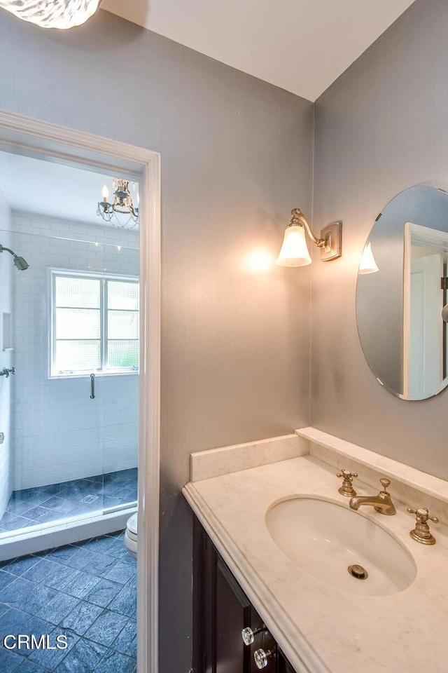 1908 Warwick Rd, San Marino, CA 91108 - full bathroom with a stall shower, vanity, toilet, tile patterned flooring, and a chandelier