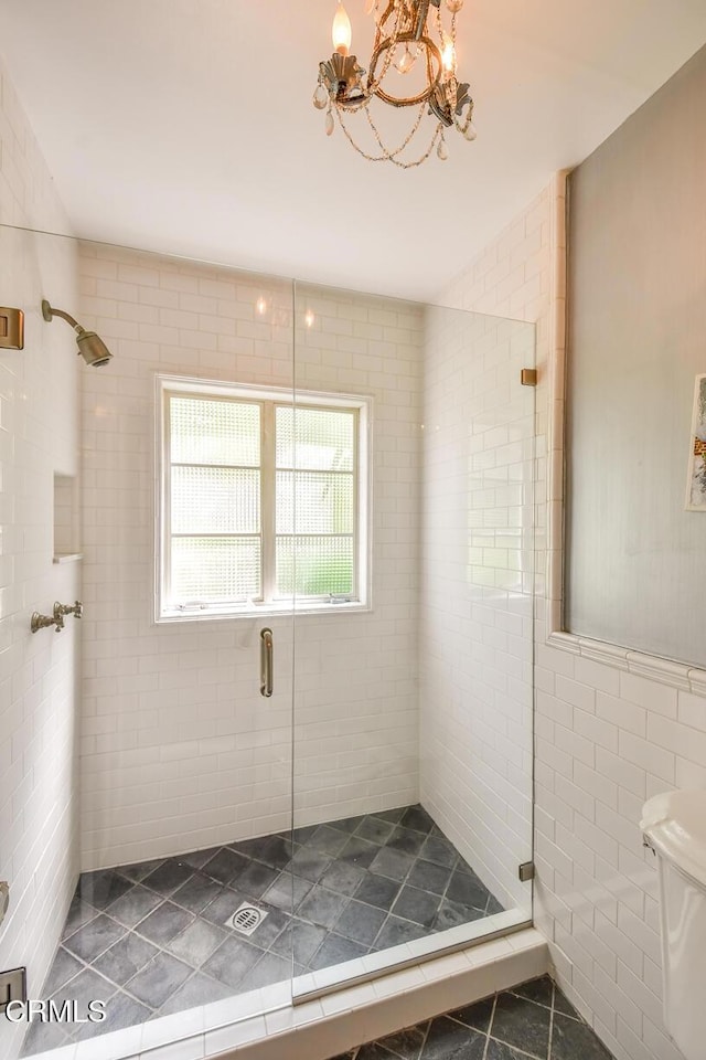 1908 Warwick Rd, San Marino, CA 91108 - bathroom featuring tile patterned floors, a stall shower, a chandelier, tile walls, and toilet