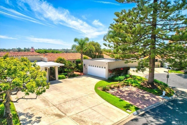2117 Vista Entrada, Newport Beach, CA 92660 - view of front of house with concrete driveway, stucco siding, an attached garage, a tile roof, and a chimney