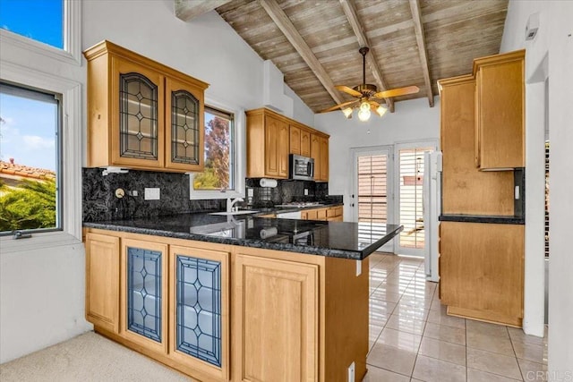 2117 Vista Entrada, Newport Beach, CA 92660 - kitchen with freestanding refrigerator, stainless steel microwave, ceiling fan, backsplash, and a peninsula