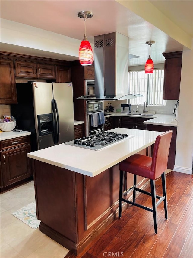 227 E Burbank Blvd Unit E, Burbank, CA 91502 - kitchen featuring refrigerator with ice dispenser, stainless steel gas stovetop, a center island, black oven, and light countertops