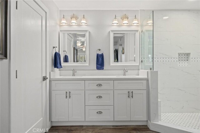 22244 Treasure Island Dr Unit 5, Canyon Lake, CA 92587 - bathroom with tiled shower, double vanity, and wood finished floors