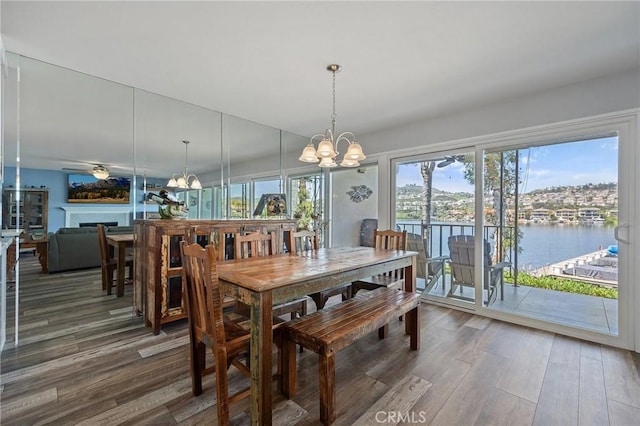 22244 Treasure Island Dr Unit 5, Canyon Lake, CA 92587 - dining space with a chandelier, wood finished floors, a water view, and a fireplace