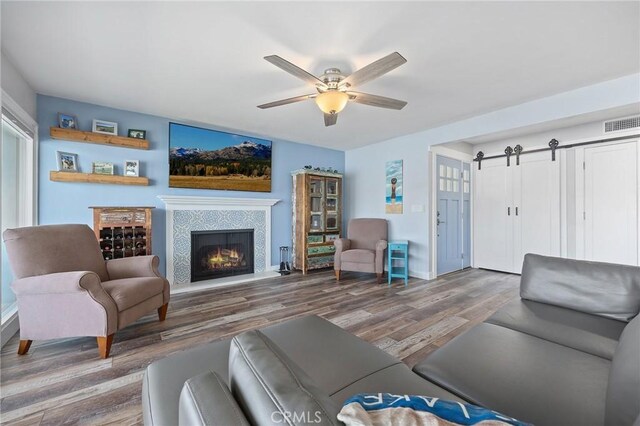 22244 Treasure Island Dr Unit 5, Canyon Lake, CA 92587 - living area with a ceiling fan, wood finished floors, a tile fireplace, and baseboards