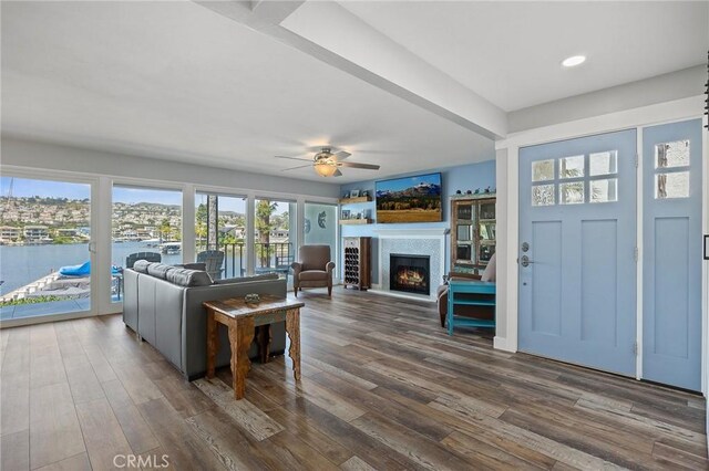 22244 Treasure Island Dr Unit 5, Canyon Lake, CA 92587 - living area with a lit fireplace, ceiling fan, dark wood-type flooring, recessed lighting, and a water view