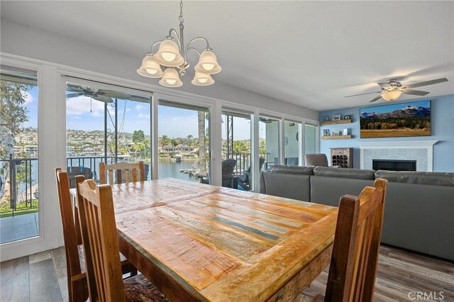 22244 Treasure Island Dr Unit 5, Canyon Lake, CA 92587 - dining space with a ceiling fan, wood finished floors, plenty of natural light, and a chandelier