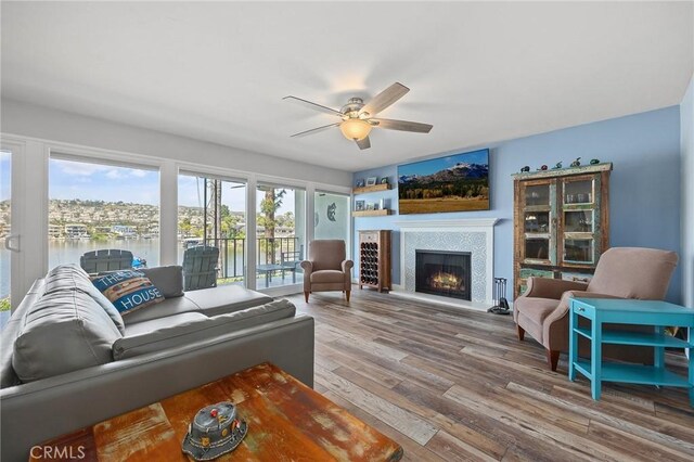 22244 Treasure Island Dr Unit 5, Canyon Lake, CA 92587 - living room with a ceiling fan, a tile fireplace, wood finished floors, and a water view