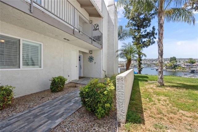 22244 Treasure Island Dr Unit 5, Canyon Lake, CA 92587 - property entrance featuring a water view, stucco siding, a lawn, and a balcony