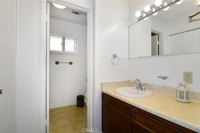bathroom with vanity, tile patterned floors, and toilet
