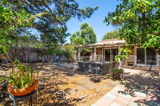 fenced backyard featuring an outdoor living space, a patio, and a pergola