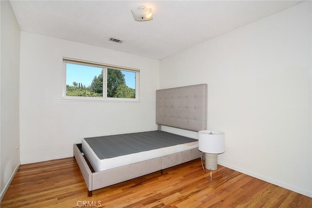 bedroom featuring wood finished floors