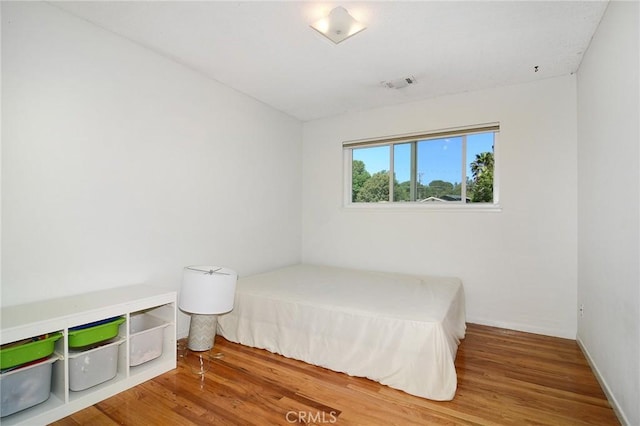 bedroom featuring wood finished floors